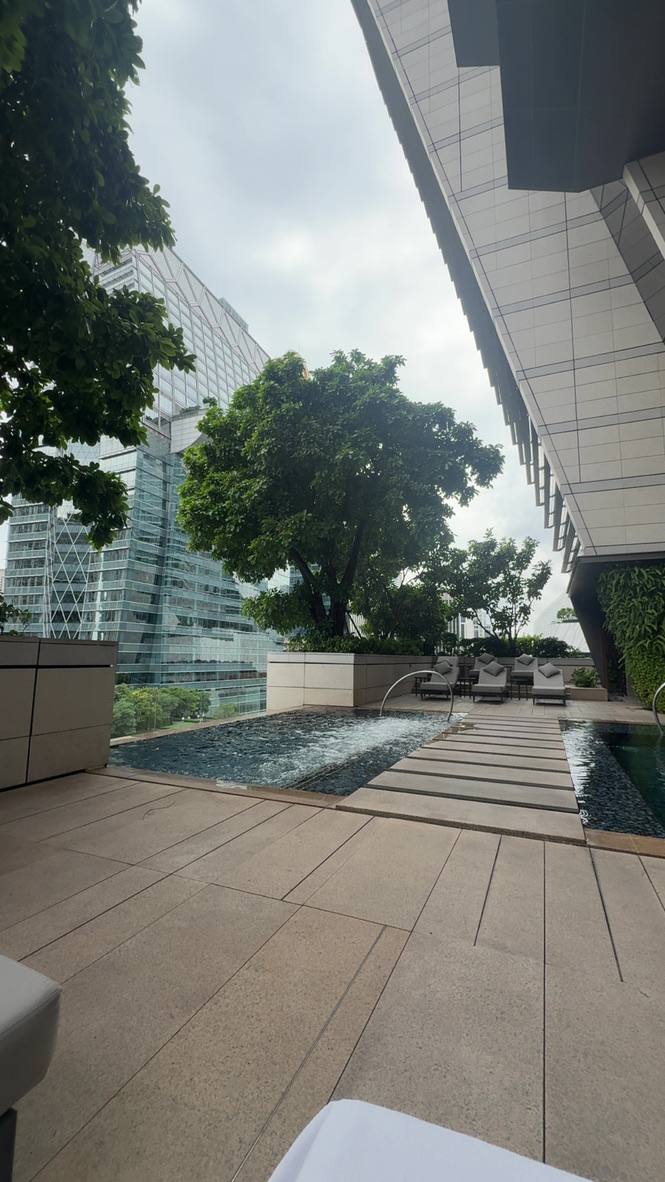 A long narrow building pool with timber decking