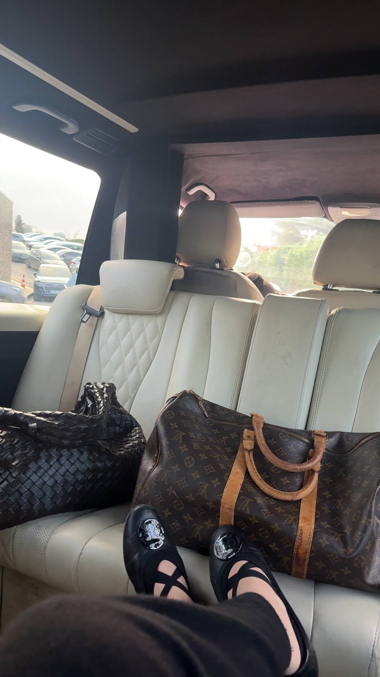 Carry-on bags loaded into the back of a car