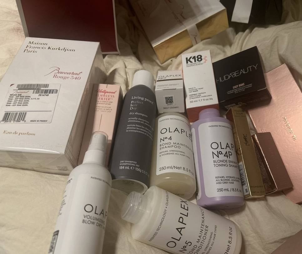 A beauty haul spread out on the bed