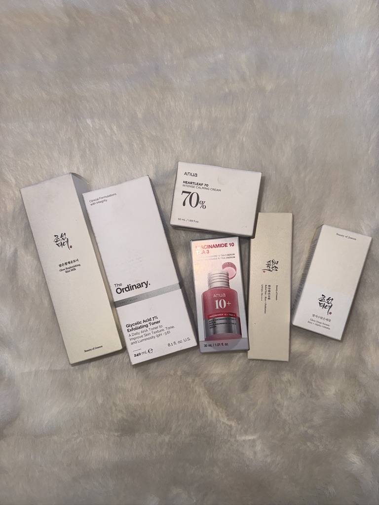 A haul of Korean skincare laid out on the bed