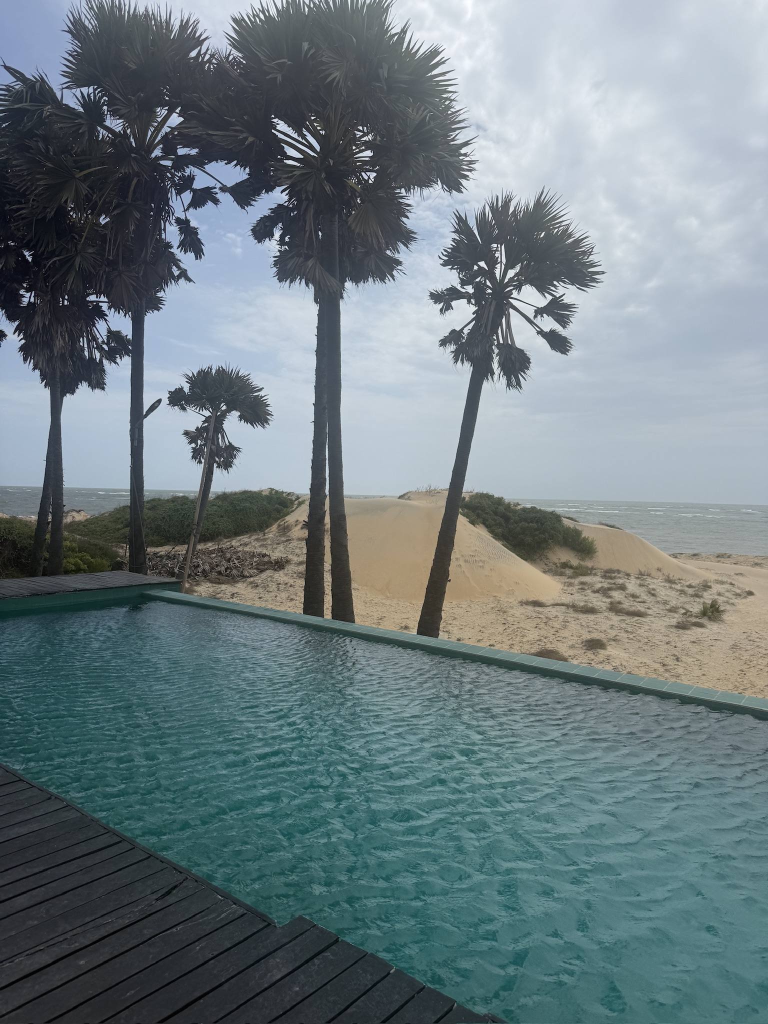 A pool set into the dunes with nothing around it