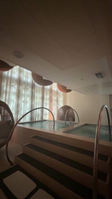A thermal pool in a spa, glass block wall behind