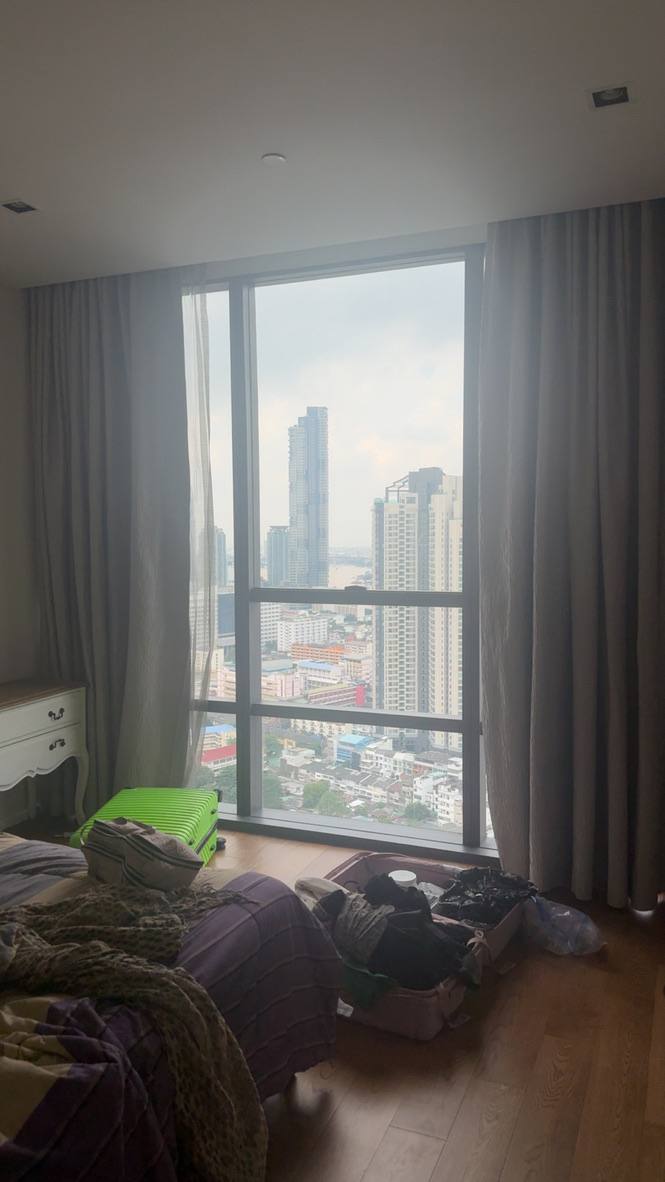 Open suitcase on a hotel bed in Bangkok